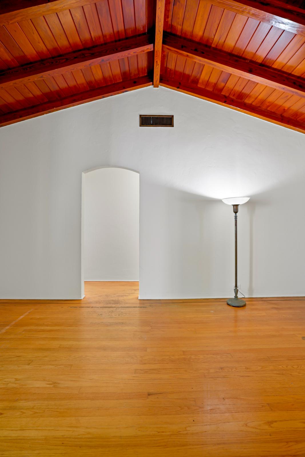 Great room view with fireplace, hardwood floors, and strong natural light