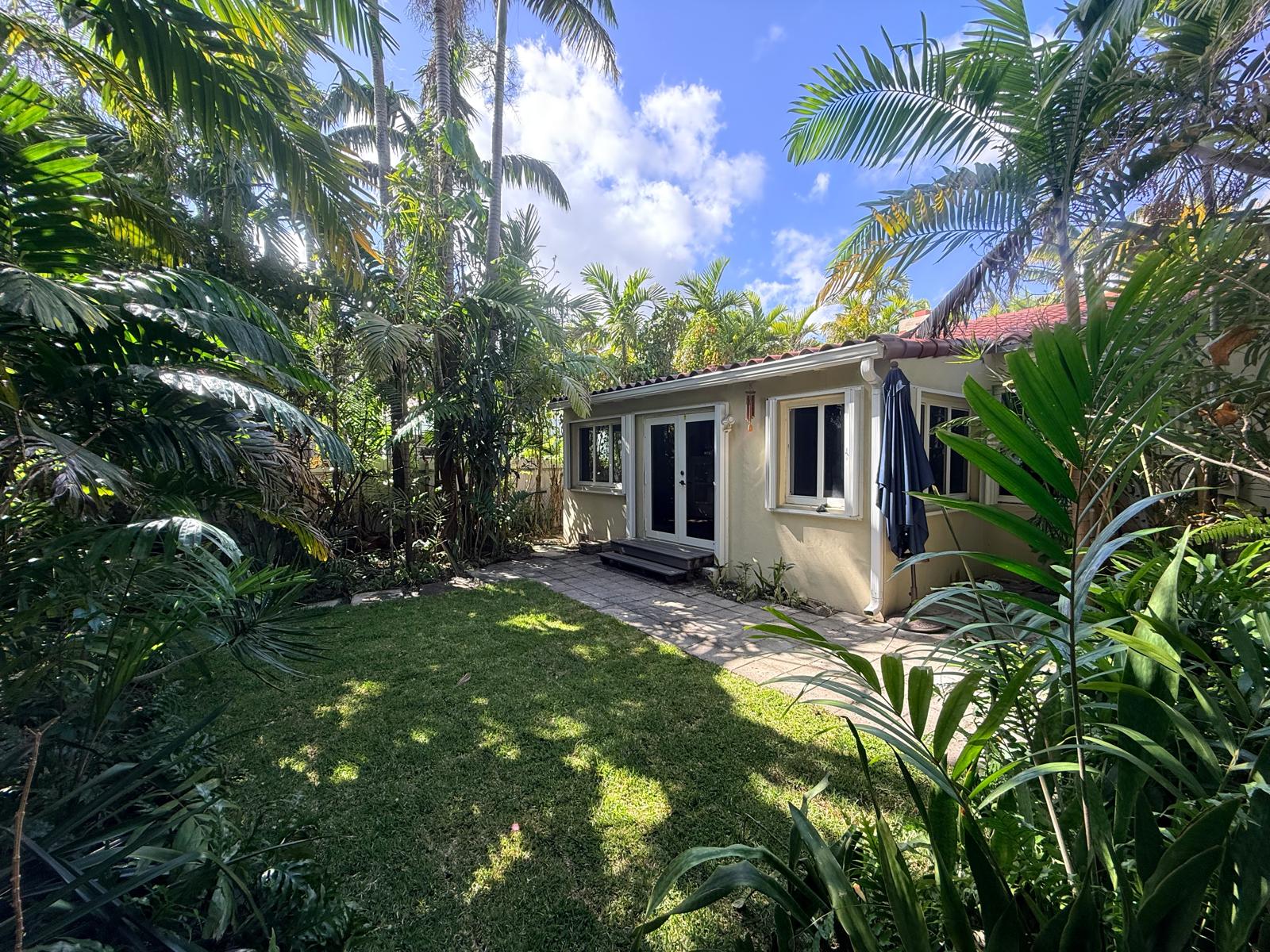 Backyard view with tropical foliage and private outdoor setting